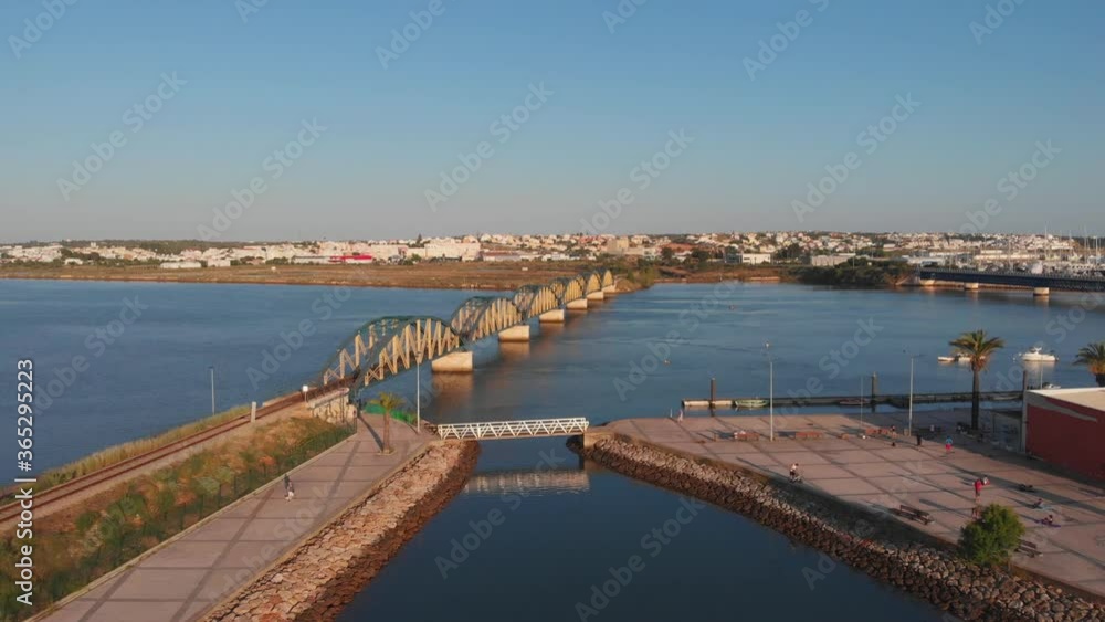 Portimao Railway Bridge during afternoon sunlight, aerial flying towards Arade river Portimao Railway Bridge during afternoon sunlight, aerial flying towards Arade river
