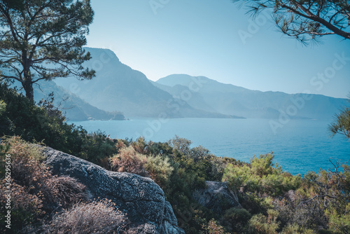 Fototapeta Naklejka Na Ścianę i Meble -  Beautiful beach with turquoise water, surrounded by high cliffs, beauty of wildlife, Faralya Turkey