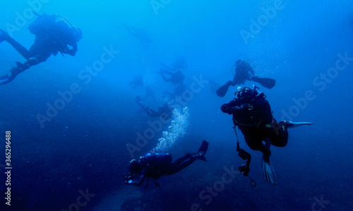 Scubadiving. Scuba divers diving at the shipwreck. © Blackbookphoto