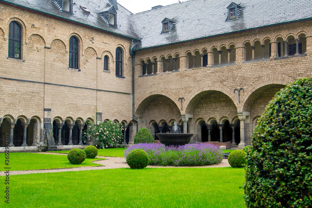 inner courtyard of a monastery in the Middle Ages in Germany, where you can enjoy a fountain and lawn
