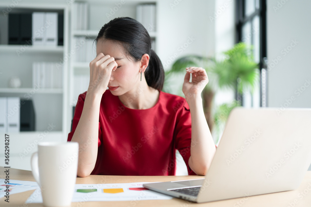 Stress businesswomen feeling not well while working in the office. Stress businesswomen feeling not well while working in the office.