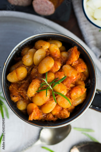 Stewed beans in tomato sauce with herbs and spices.  Top view. photo