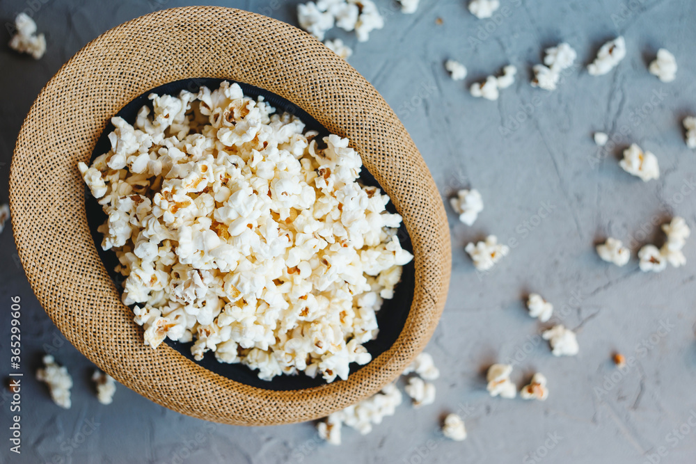 Salted popcorn in a straw hat