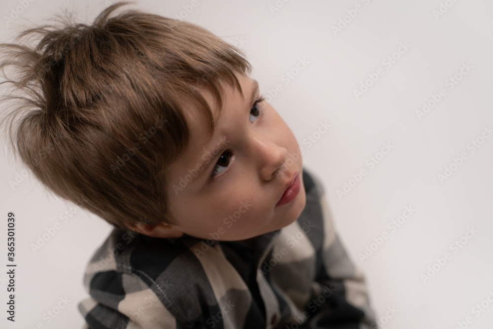 A brooding little boy looks into the distance A brooding little boy looks into the distance