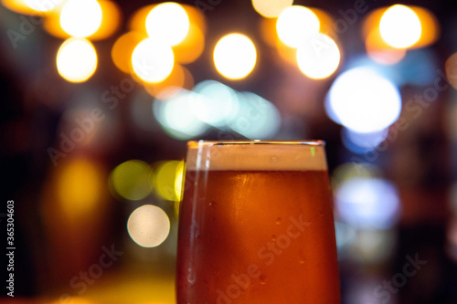  A glass of lager beer and bokeh background. Pary, Happiness Concept. Copy Space for text.