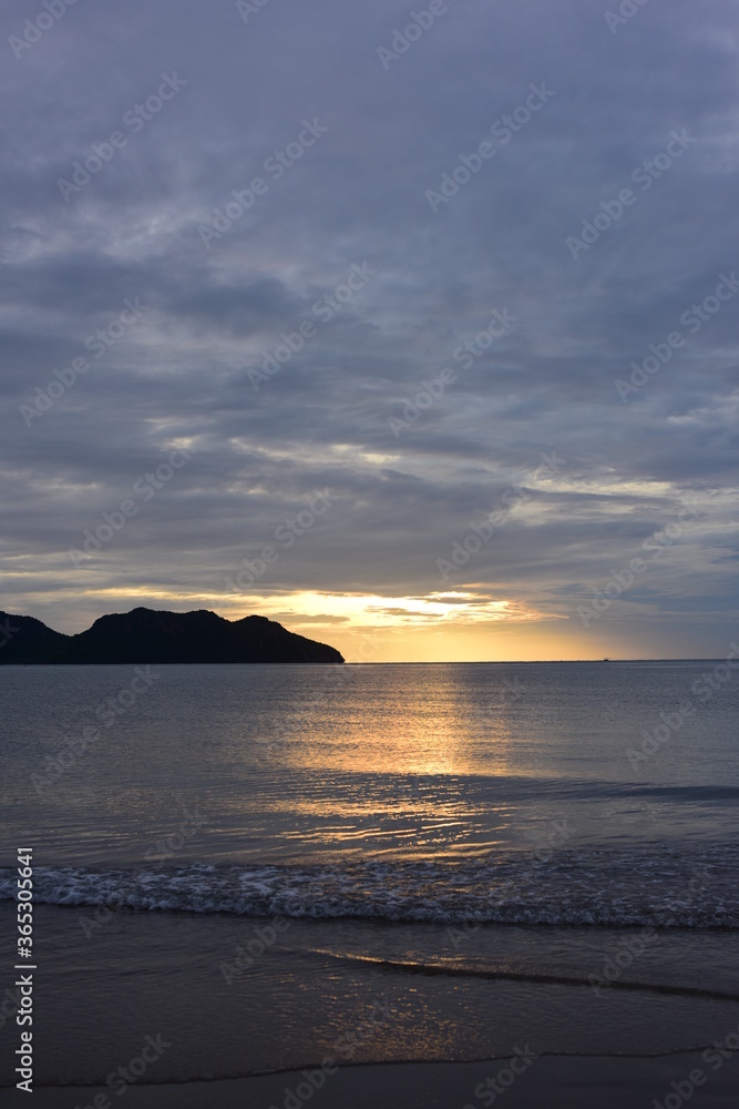 Early morning sea view. The sunrise view against the golden yellow sky