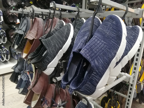 Men's shoes were hung for sale in the mall.