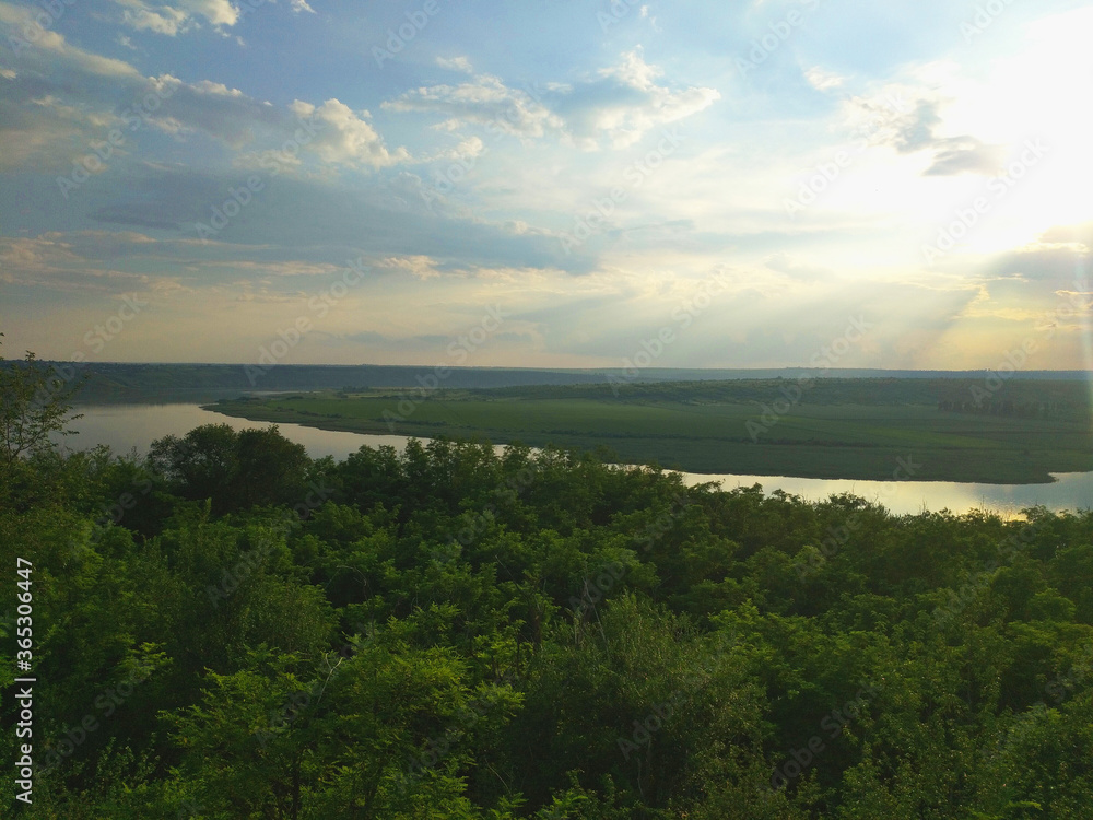 river bend, forest and sky in the sun at sunset. beauty in nature