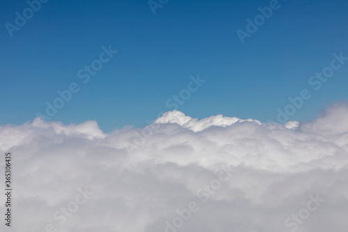white puffy clouds under clear blue sky © travelview
