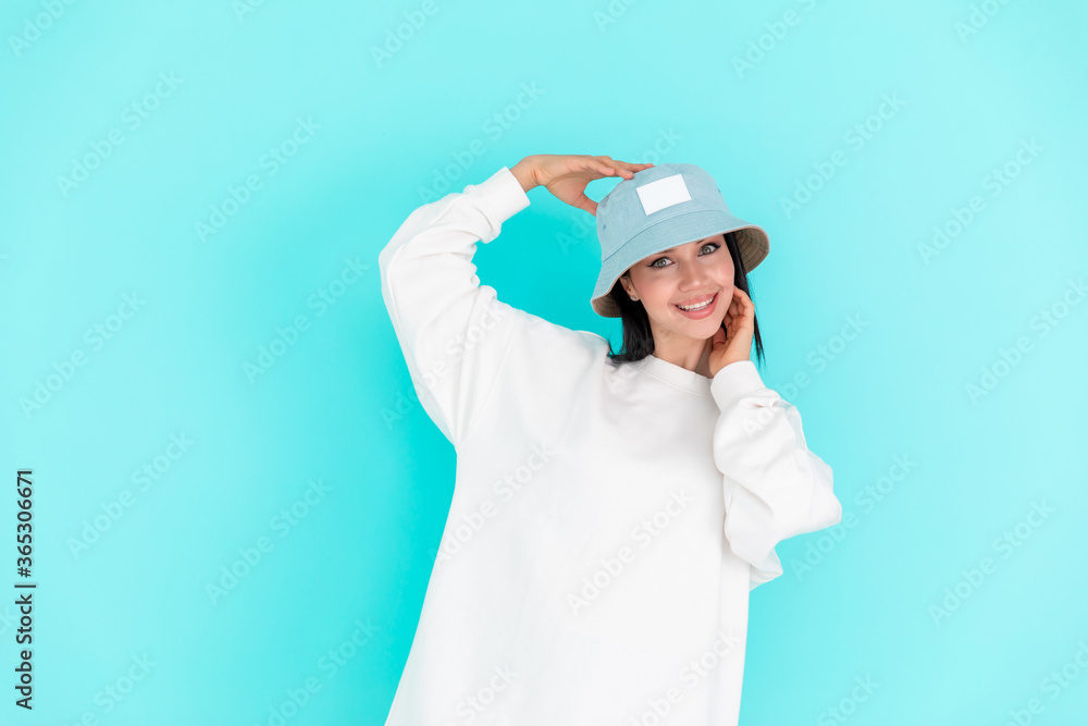 Fashion girl in blank sweatshirt jacket on a blue background Fashion girl in blank sweatshirt jacket on a blue background
