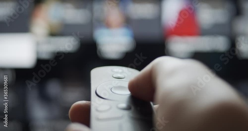 User browsing video streaming content with wireless remote control on a smart tv