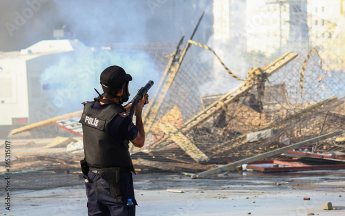 Turkish Riot Police using tear gas gun, aiming at protesters photo