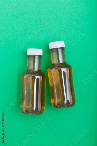 Bottles of ice tea, top view with green background