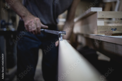 Older man  carpenter in his workshop
