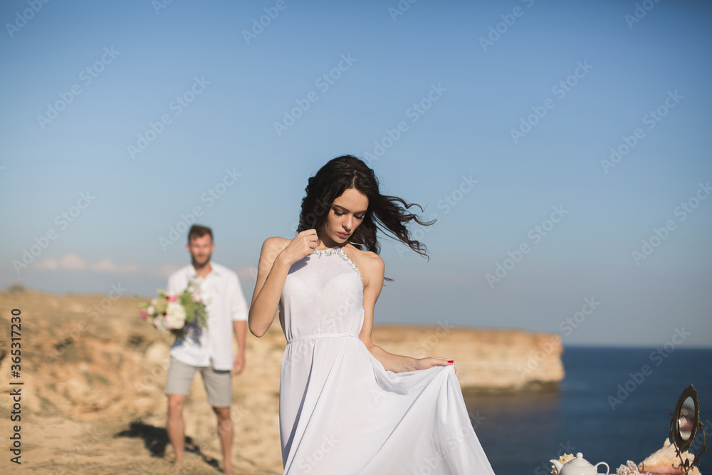 Beautiful young couple on a date. The guy brings flowers. Beautiful young couple on a date. The guy brings flowers.