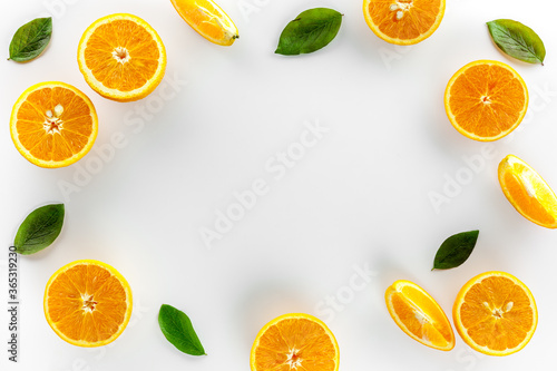 Orange slices on white background top view frame