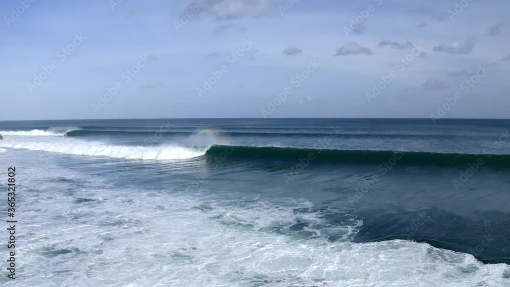 Surfers crushed by large wave in Balangan Beach near New Kuta Golf Course, Aerial dolly in shot Surfers crushed by large wave in Balangan Beach near New Kuta Golf Course, Aerial dolly in shot