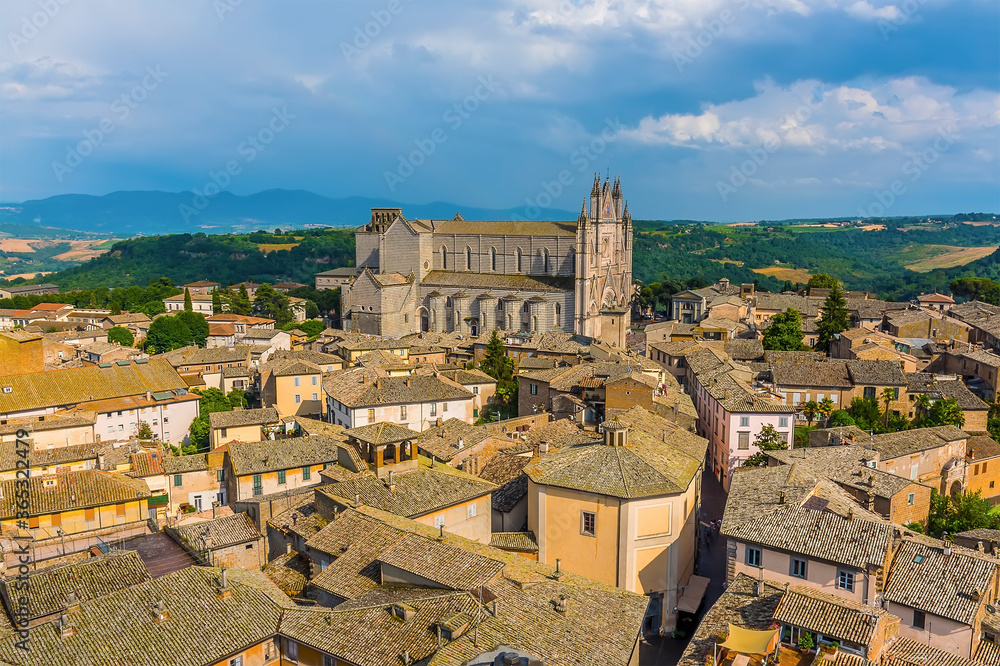 The cathedral in Orvieto, Italy towers above the surrounding roof tops in summer