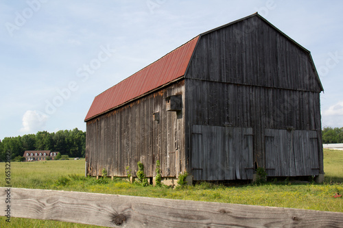 red roofed barn in the field