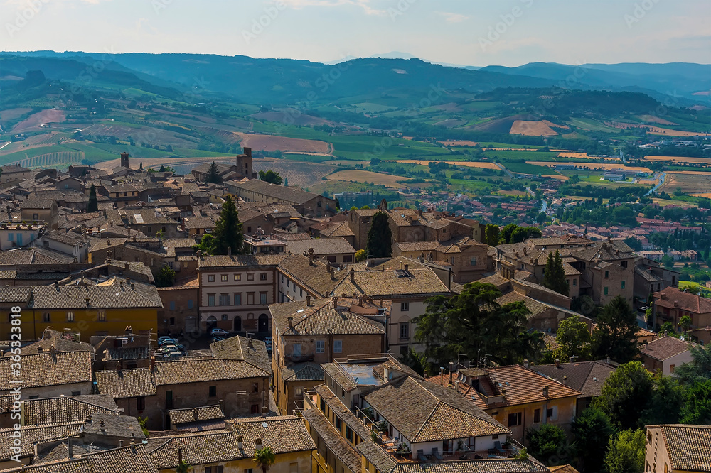 The roof tops of Orvieto, Italy rise above the surrounding countryside in summer