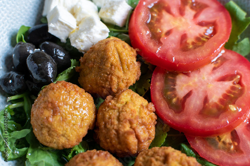 falafels served with tomato feta cheese and olives 