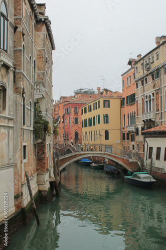 canal in venice italy with bridge and boats in winter fog © Candace