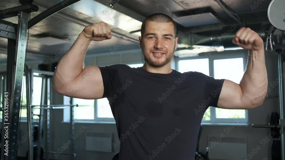 Young athlete in the gym shows his strong hands in front of the camera. Beginner athlete Young athlete in the gym shows his strong hands in front of the camera. Beginner athlete