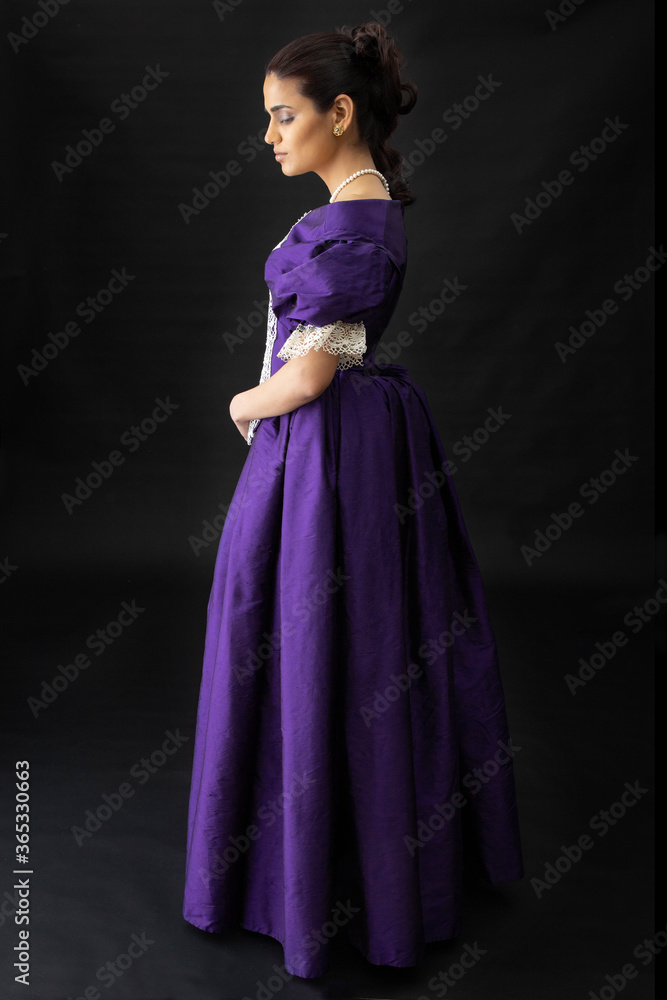 Attractive, dark-haired young woman wearing a renaissance style dress with lace detail Attractive, dark-haired young woman wearing a renaissance style dress with lace detail