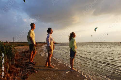family on the beach watching the sunset