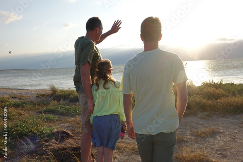 family on the beach watching the sunset
