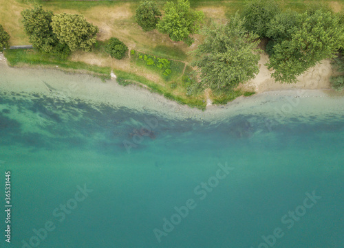 Aerial view of beach with tranquil water on coastline. Scenic landscape with beautiful beach and trees.