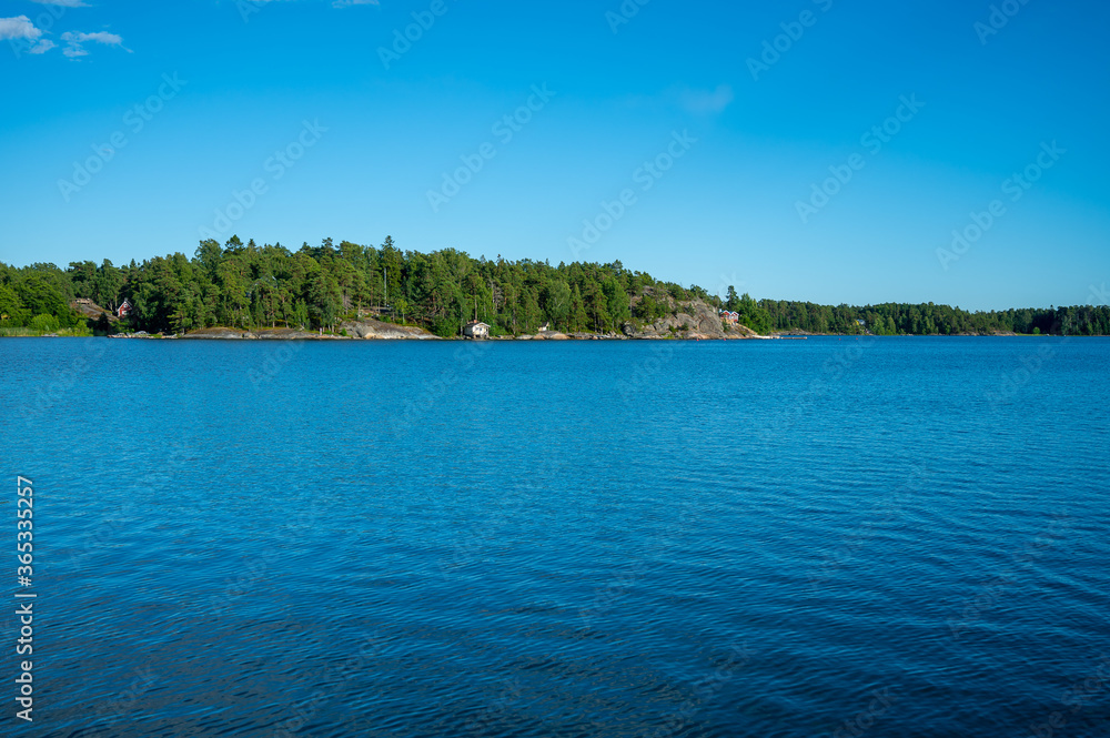 A view of a Finnish archipelago in Helsinki during a sunny summer day. A view of a Finnish archipelago in Helsinki during a sunny summer day.