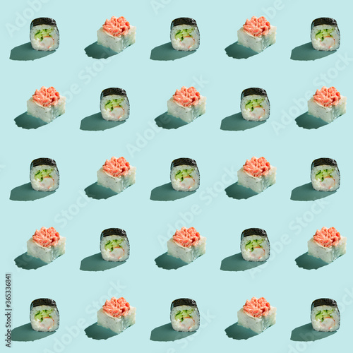 Pattern of sushi rolls on a light blue background