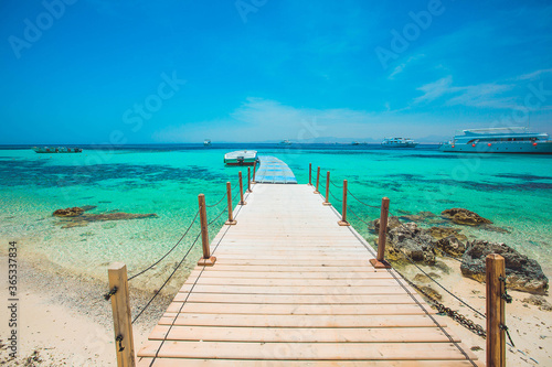 wooden pier on a tropical beach © Ganna