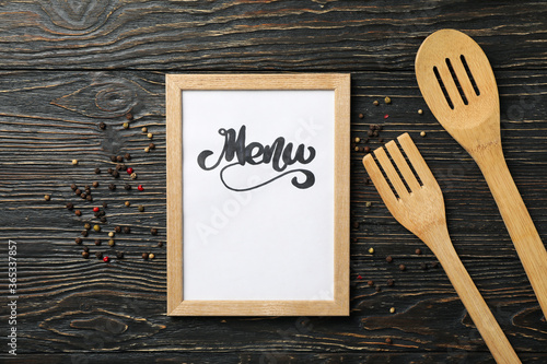 Frame with text Menu and cutlery on wooden background
