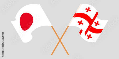 Crossed and waving flags of Georgia and Japan