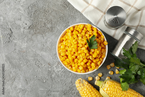 Composition with fresh raw corn on gray background, top view