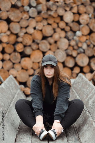 Attractive seriously young woman in black clothes looking at the camera. High quality photo © Ivan Kozachenko