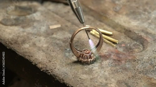 Craftsman special diamond welding gold ring.Diamond ring jewelery product. Close up craftsman workshop macro shooting. hand made jewelery making. in jewelery master workshop. hand made rose gold ring