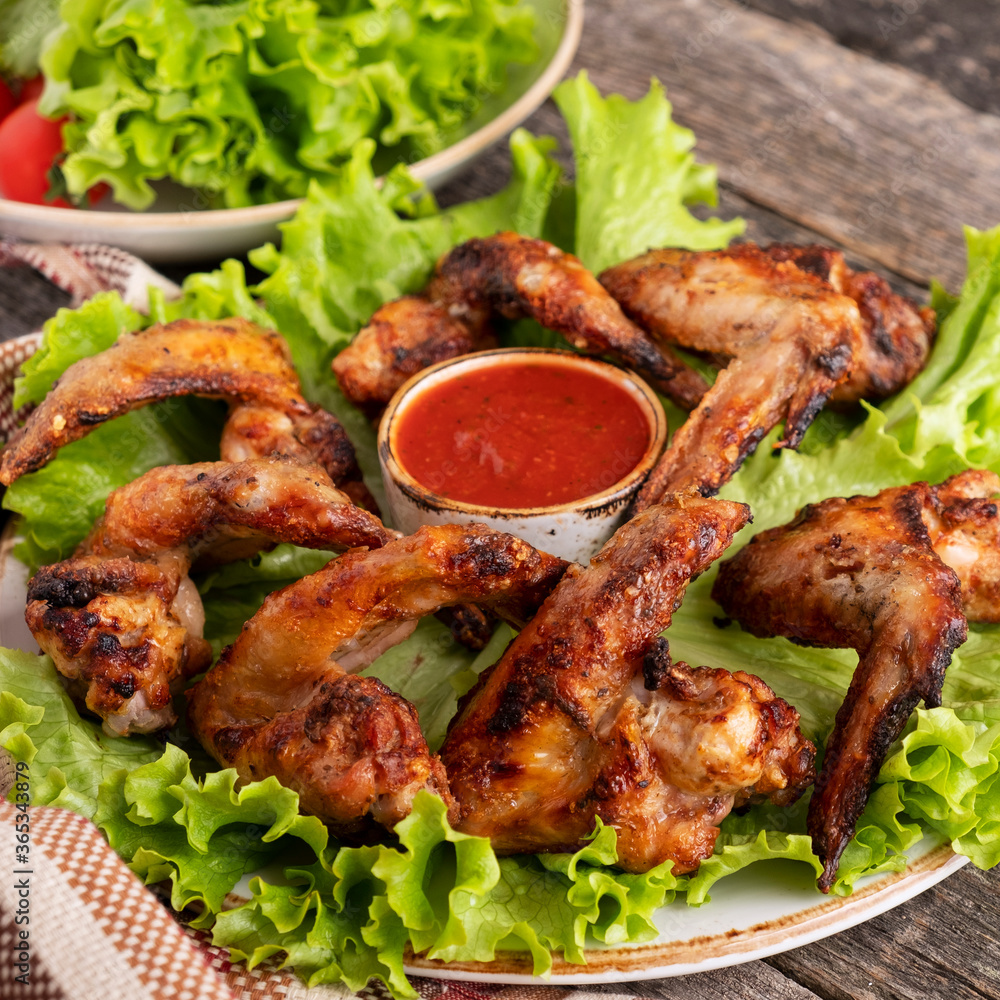 Bbq chicken wings garnish with red sauce. Closeup Bbq chicken wings garnish with red sauce. Closeup
