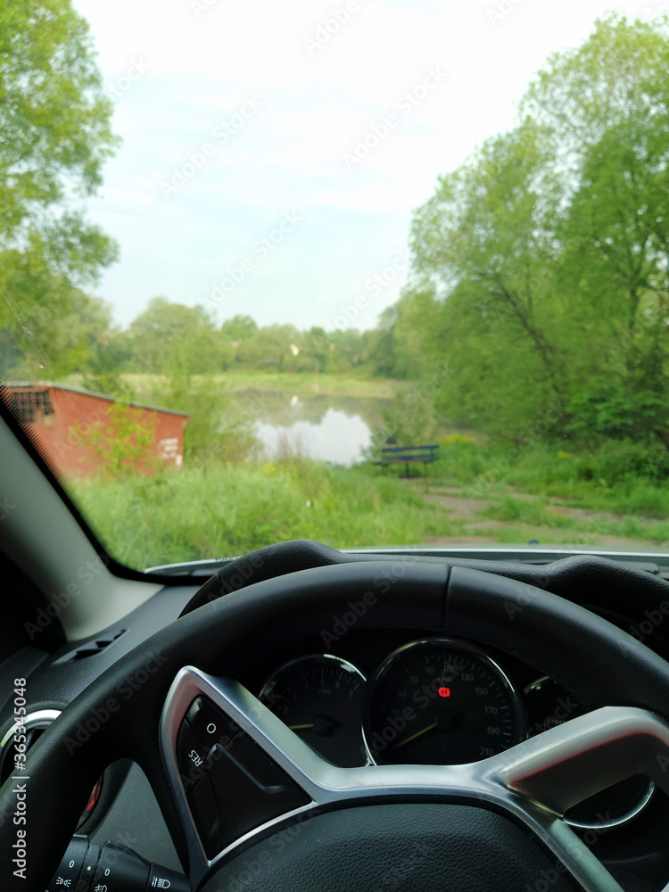 image of the steering wheel of a car and view through the windshield image of the steering wheel of a car and view through the windshield