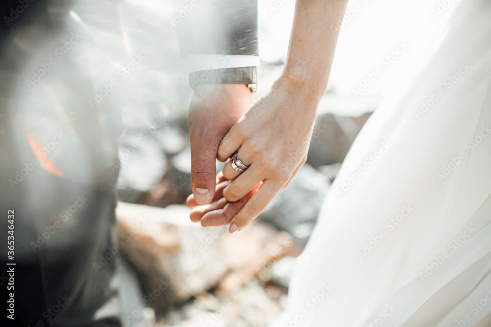 bride and groom holding hands