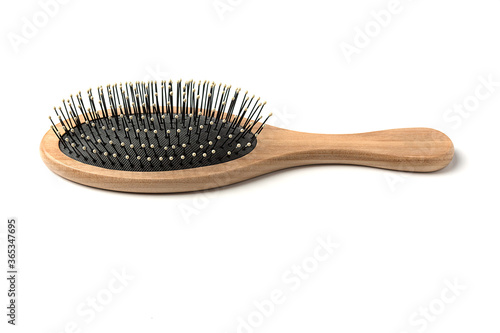 Beauty Tools. Massage hairbrush with wooden handle on a white background