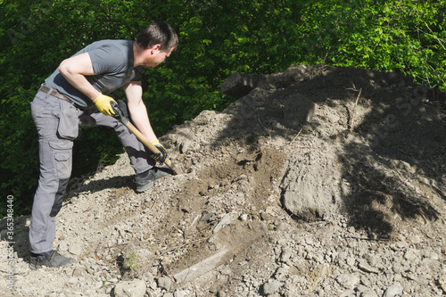A man spreading soil masse around.