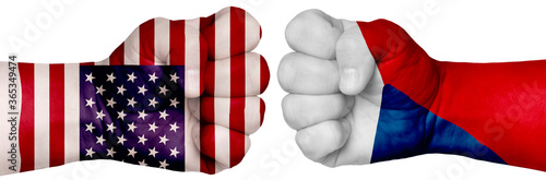 Fototapeta Naklejka Na Ścianę i Meble -  Two hands are clenched into fists and are located opposite each other. Hands painted in the colors of the flags of the countries. Czech Republic vs USA