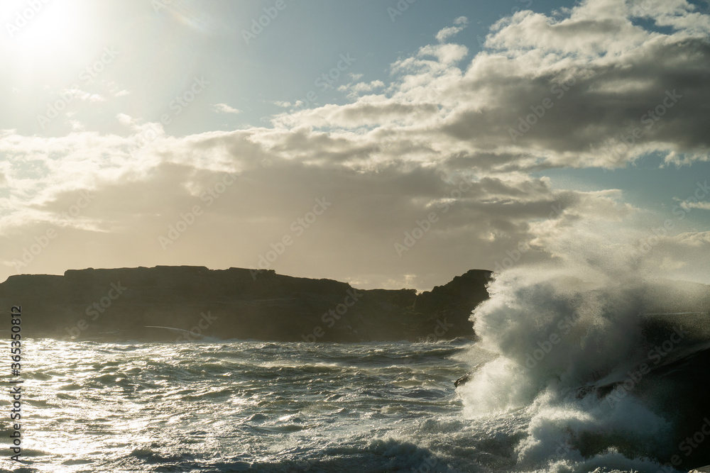 Beautiful landscape of the ocean as big waves come crashing in over the rocky shore