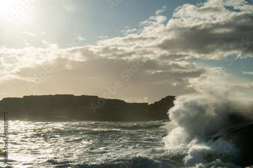 Beautiful landscape of the ocean as big waves come crashing in over the rocky shore