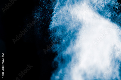 Giant and furious water wave splash on black background. Abstract background concept.