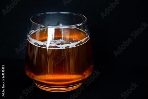Glass of delicious beer. Light alcohol drink. Dark background. 