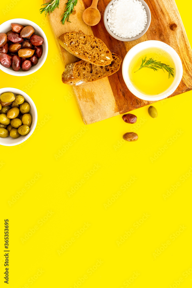 Appetizer. Olives in bowl and bread on cutting board from above space for text Appetizer. Olives in bowl and bread on cutting board from above space for text